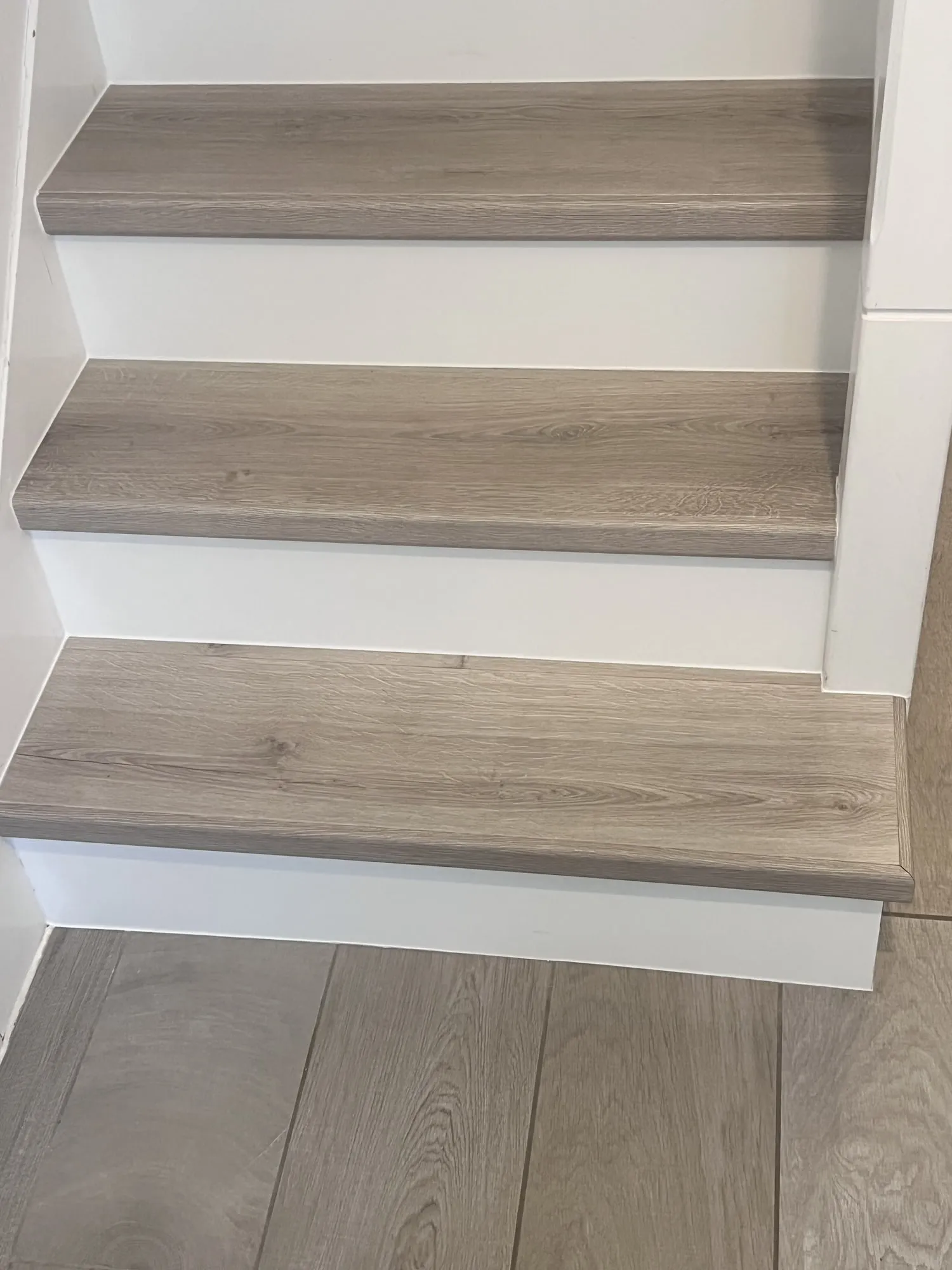 Laminate stairs with custom white risers in Didcot