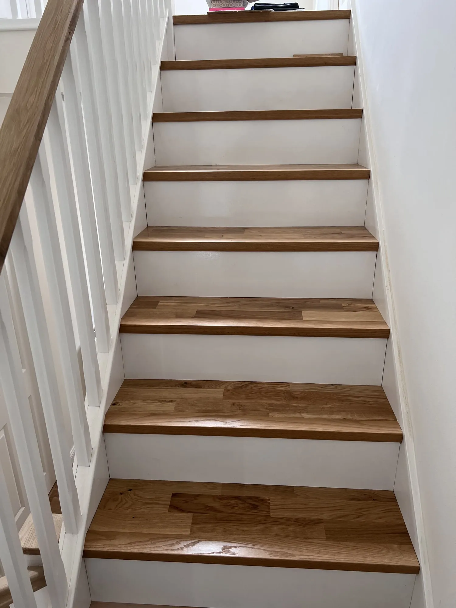 Kährs engineered wood stairs with white risers, fitted by Nicolai