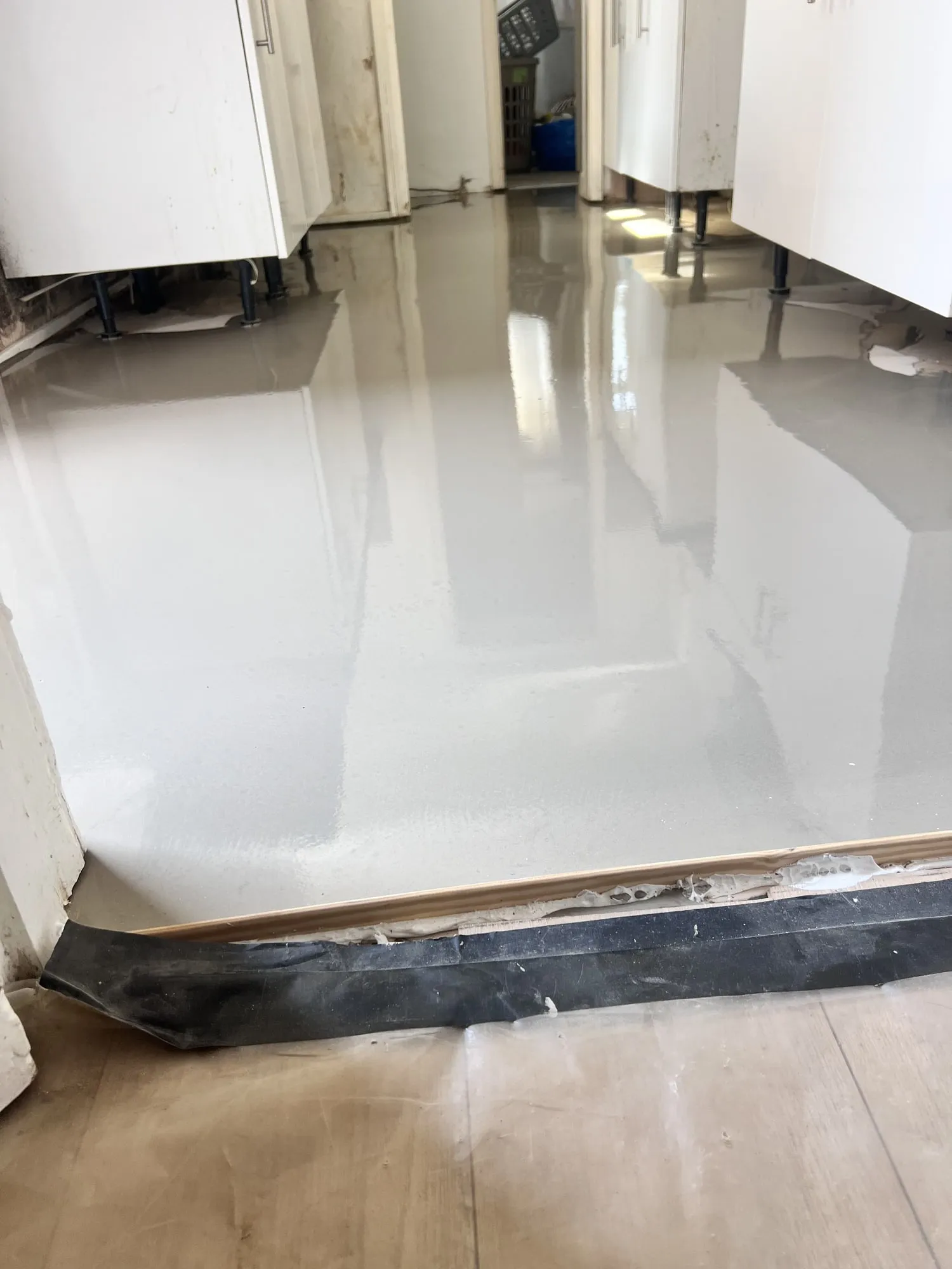 Self-levelling compound laid in a hallway before the new floor